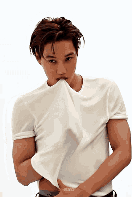 a man wearing a white shirt with the word exo on the sleeve
