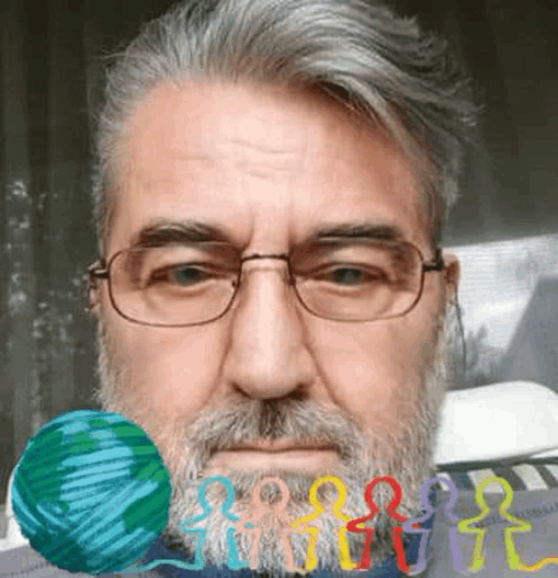 a man with a beard and glasses is holding a ball of yarn in his mouth .