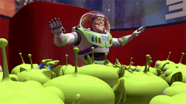 buzz lightyear is surrounded by green aliens in a scene from toy story