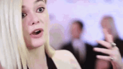 a close up of a woman 's face with a surprised expression .