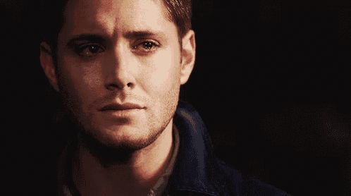 a close up of a man 's face with a tear running down his face .