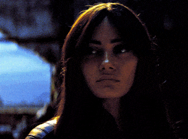 a close up of a woman 's face with a blurred background