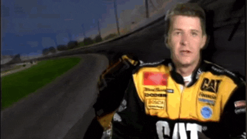 a man is wearing a yellow and black cat jacket