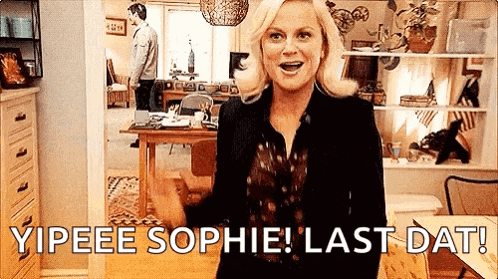 a woman is standing in a living room with the words `` yipee sophie last dat '' written on the screen .