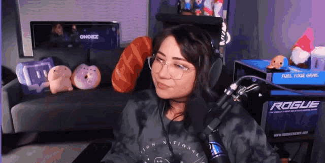 a woman wearing headphones and a shirt that says rogue on it
