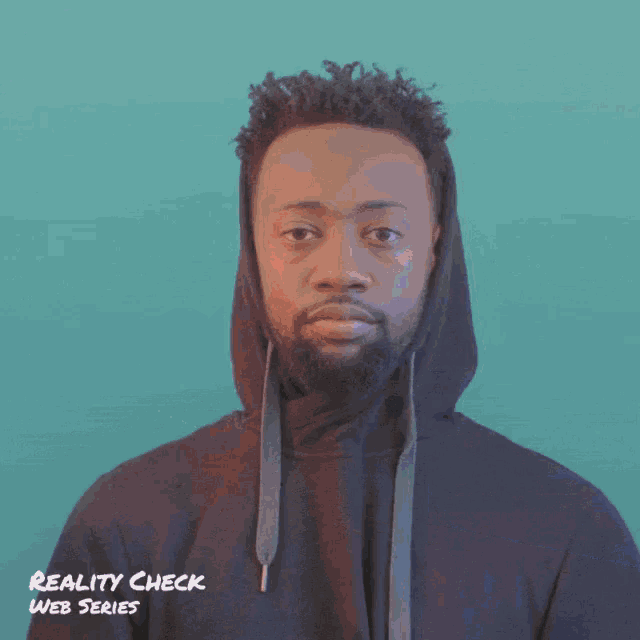 a man in a hooded sweatshirt is being measured by a reality check web series person