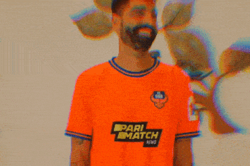 a man with a beard is wearing an orange shirt that says rl watch next