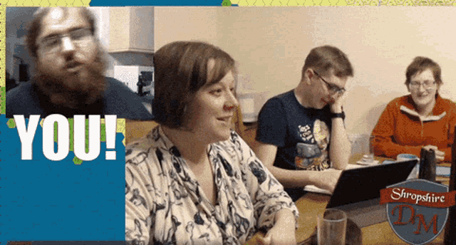 a group of people sitting at a table with the words " you " on the bottom