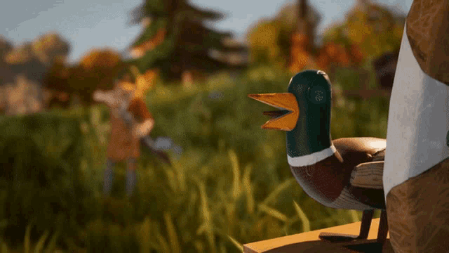 a wooden duck with a yellow beak is sitting on a wooden table