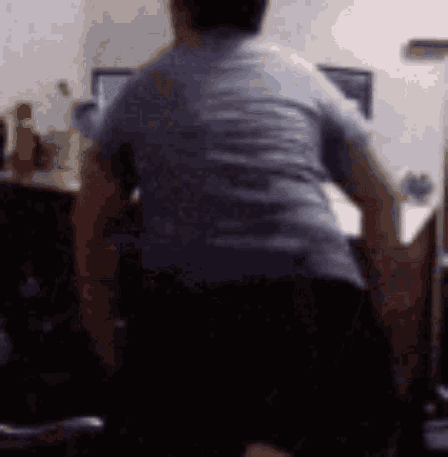 a blurry picture of a man in a blue shirt dancing