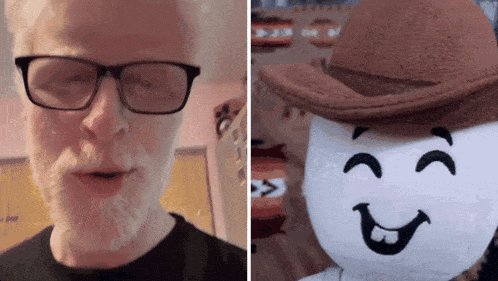 a man wearing glasses next to a stuffed character