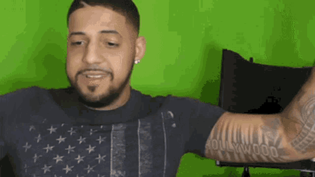 a man with a tattoo on his arm that says " hollywood "