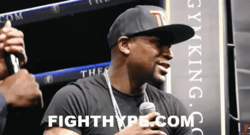 a man holding a microphone with fighthype.com written below him