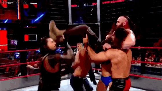 a group of wrestlers are wrestling in a ring .