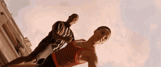 a man and a woman are standing next to each other