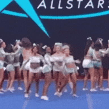 a group of cheerleaders are dancing in front of a sign that says all stars