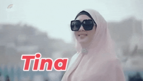 a woman wearing a hijab and sunglasses with the name tina written on the bottom