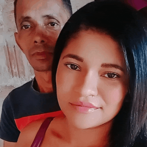 a man and woman are posing for a picture together