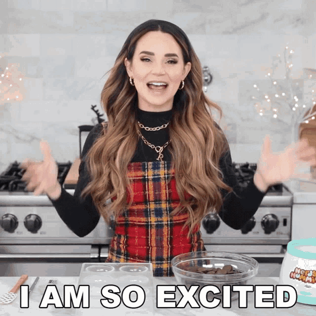 a woman says i am so excited in front of a bowl of chocolate chips
