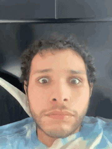a man with a beard is making a funny face with his mouth open