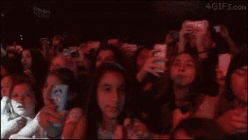 a crowd of people are taking selfies at a concert with the website 4gifs.com visible in the corner