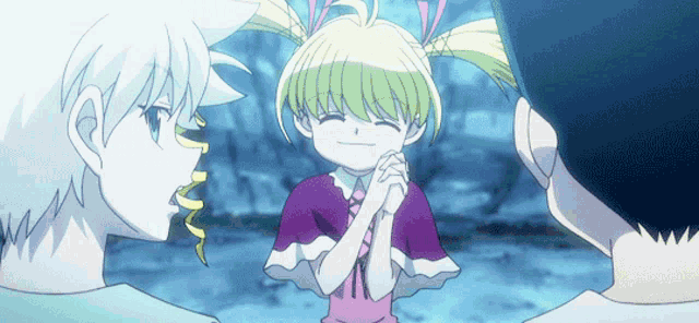 a girl with pigtails is smiling while standing next to two other girls