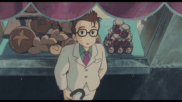 a man in a suit stands in front of a display of bread and jam