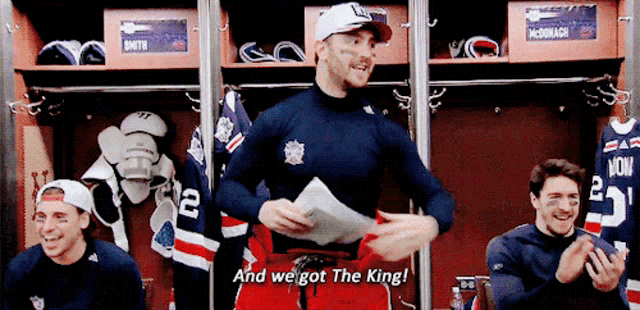 a group of hockey players are in a locker room and one of them says " and we got the king "