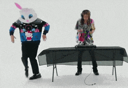 a man in a hello kitty sweater is standing next to a woman in a bunny costume