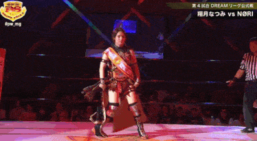 a woman in a wrestling ring with a sash that says dream on it