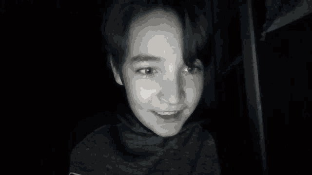 a blurry picture of a child 's face with a black background
