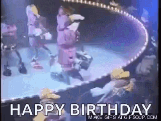 a happy birthday gif with a group of people on stage