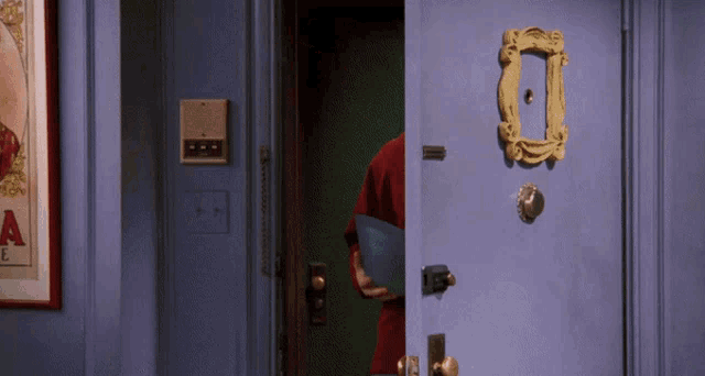 a blue door with a picture frame on it and a sign that says a on it