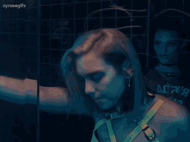 a woman in a neon yellow harness is standing in front of a mirror .