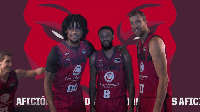a group of basketball players are posing in front of a red background that says mos aficio