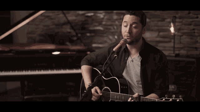 a close up of a person playing a guitar with a capo