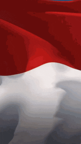 a red white and blue flag is being blown in the wind