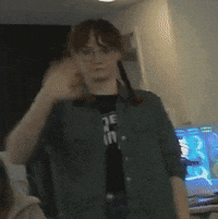 a woman wearing glasses and a shirt that says ' de in ' on it