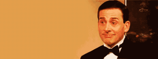 a man in a tuxedo is making a funny face .