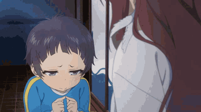 a little boy with a sad look on his face looks at a woman