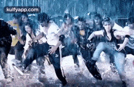 a group of people are dancing in the rain in a room .