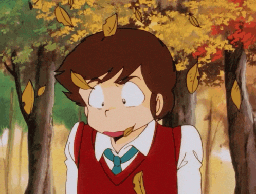 a boy in a red vest and tie is standing in a forest