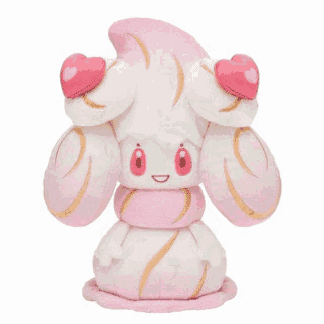 a pink and white stuffed animal with a pink bow on its back