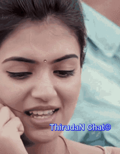 a close up of a woman 's face with the words thiruda n chat written below it