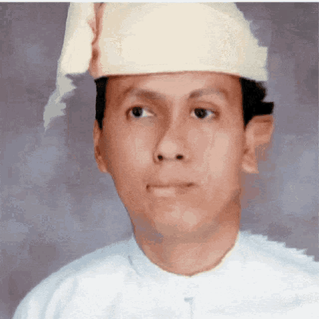a man is wearing a white shirt and a white hat