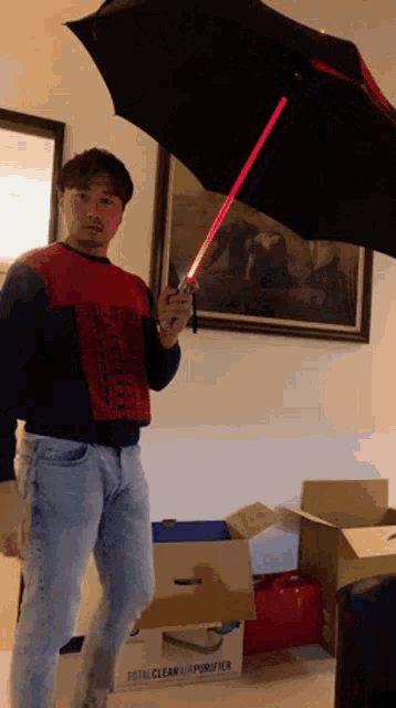 a man holding an umbrella in front of a total clean air purifier