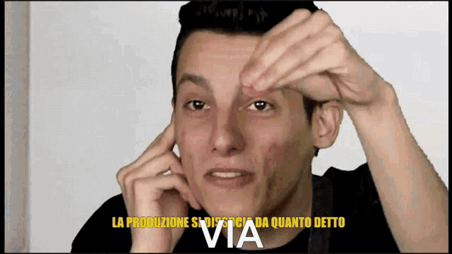 a man 's face is shown with the words via written in yellow