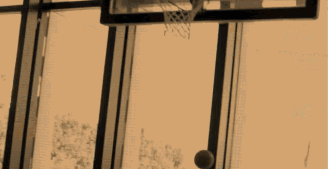 two men are playing basketball on a court and one has a shirt that says twitch