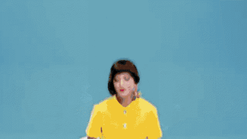 a woman in a yellow dress is laying in a chair next to a ice cream sandwich