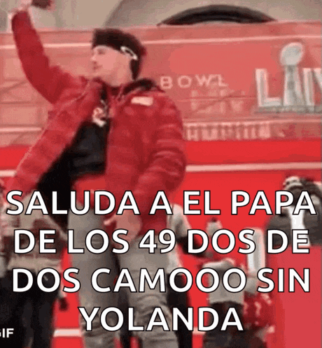 a man in a red jacket stands in front of a sign that says bowl